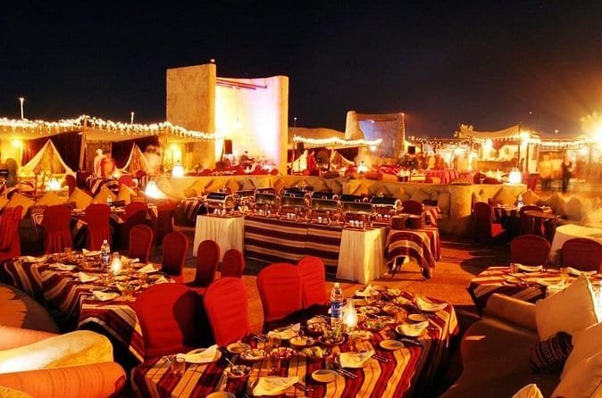Guests enjoying dinner at a Dubai desert safari camp