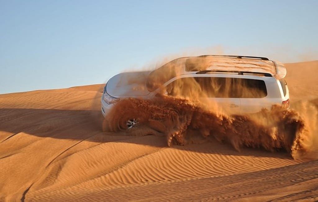 Evening desert safari Dubai by Land Cruiser on red dunes